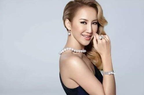 Coco Lee performing on stage, radiating confidence and talent.